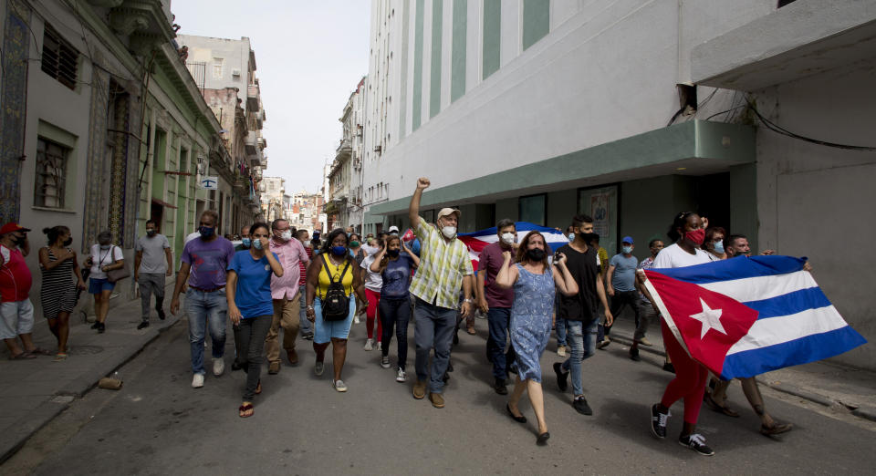Backers of the government march in Havana, Cuba, Sunday, July 11, 2021. Hundreds of supporters of the government took to the streets while hundreds protested against ongoing food shortages and high prices of foodstuffs. (AP Photo/Ismael Francisco)