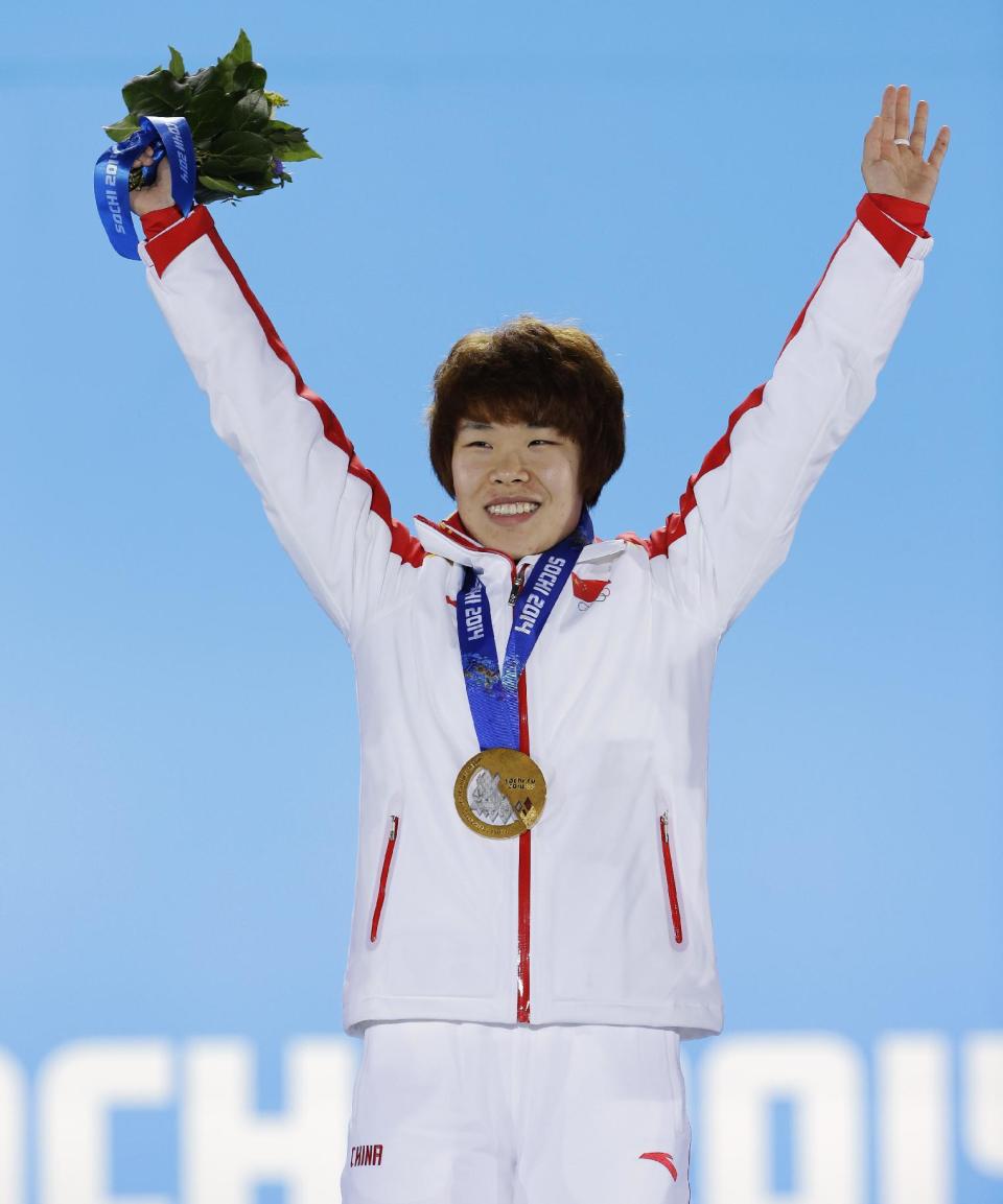 Women's 1,500-meter short track speedskating gold medalist Zhou Yang of China gestures while standing on the podium during the medals ceremony at the 2014 Winter Olympics, Saturday, Feb. 15, 2014, in Sochi, Russia. (AP Photo/David J. Phillip )