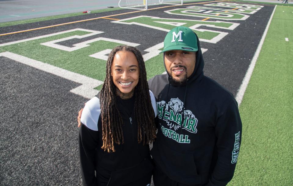 Brittany Butler, left, and her brother Chris Hall stand on the football field at McNair High School in Stockton on Nov. 17, 2023. Butler is the head coach of the school's girls flag football team and Hall is the boys varsity football head coach.