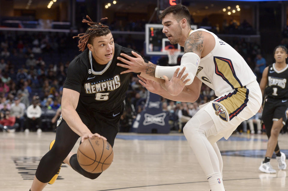 Memphis Grizzlies forward Kenneth Lofton Jr. (6) drives against New Orleans Pelicans center Willy Hernangomez in the second half of an NBA basketball game Friday, Nov. 25, 2022, in Memphis, Tenn. (AP Photo/Brandon Dill)