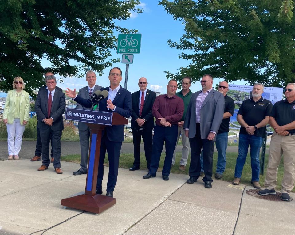 Gov. Josh Shapiro speaks during a launch of the Bayfront Parkway construction project on Sept. 15. Also shown, at left, are Christina Marsh of Erie Insurance, PennDOT District Executive Brian McNulty (partially hidden), PennDOT Secretary Mike Carroll and Erie Mayor Joe Schember. At right are representatives of Erie's building trades and other officials.