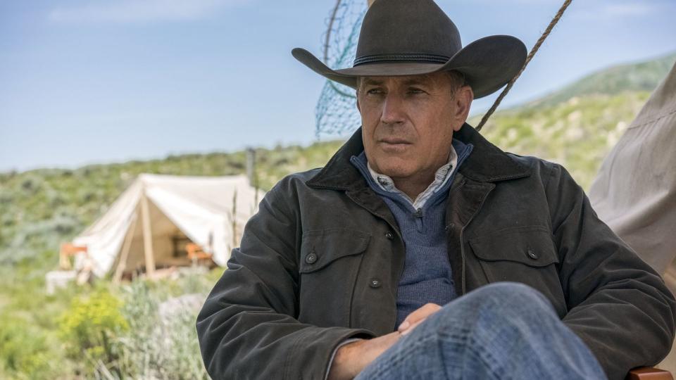 Kevin Costner sits in a chair as John Dutton in Yellowstone scene