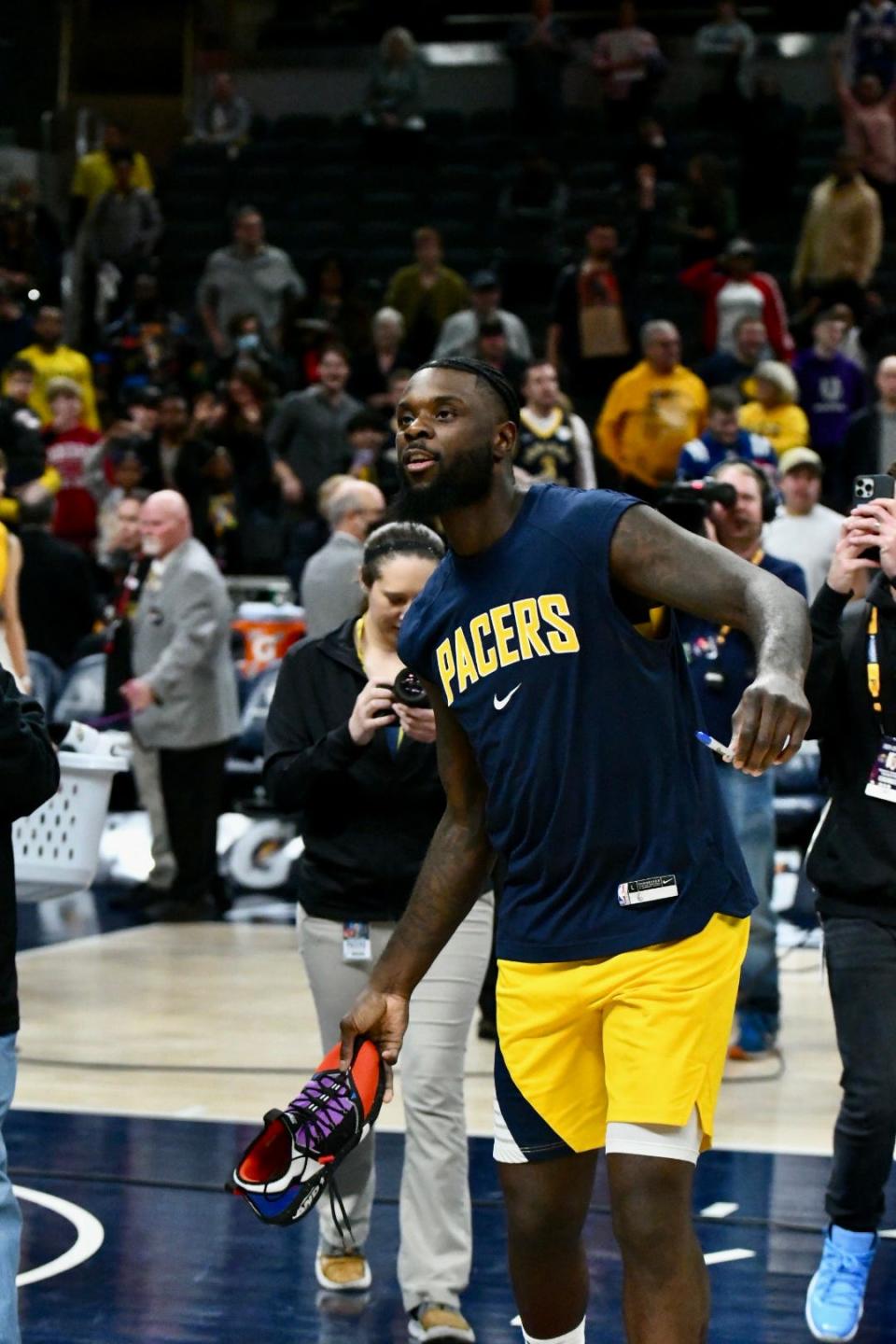 Lance Stephenson tosses an autographed sneaker into the crowd after Indiana hosted Philadelphia at Gainbridge Fieldhouse in Indianapolis on April 5, 2022.