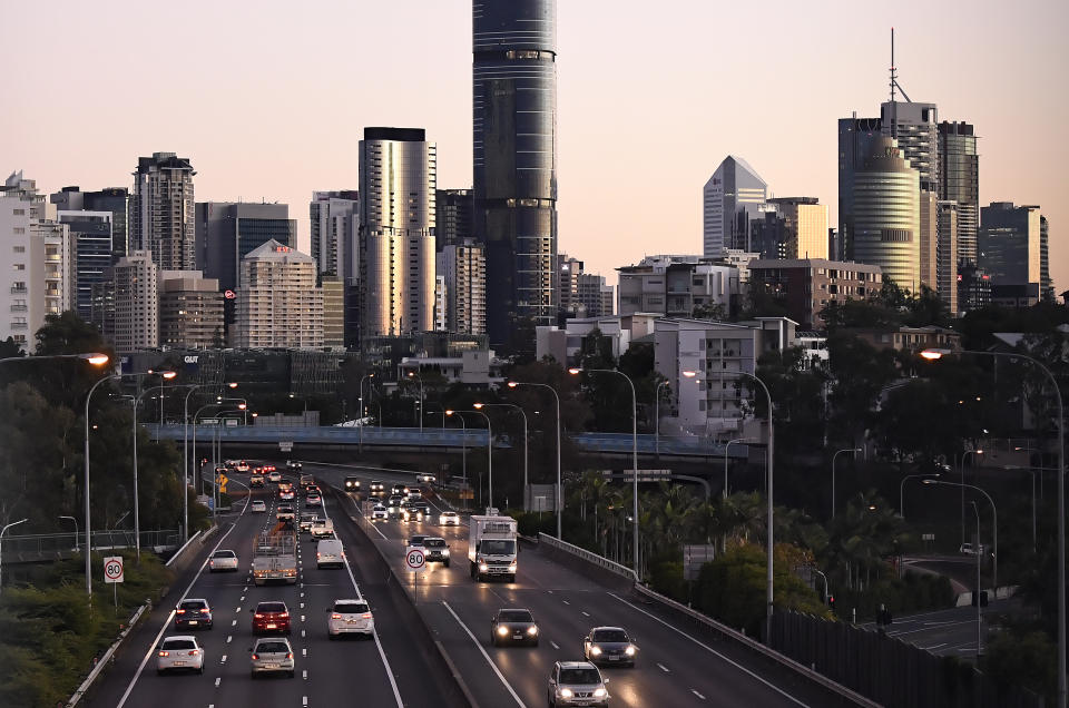 Stock image of traffic in and out of the central business district at dawn in Brisbane.