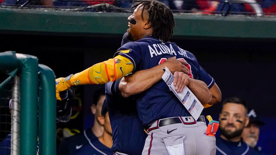Atlanta Braves' Ronald Acuña Jr. gets a hug from the team's manager, Brian Snitker, after hitting a solo home run during a game against the Washington Nationals on Friday, Sept. 22.  - Andrew Harnik/AP