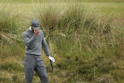 United States&#39; Tiger Woods prepares to take a shot from the rough on the fifth hole during the first round of the British Open Golf Championship at the Old Course, St. Andrews, Scotland, Thursday, July 16, 2015. (AP Photo/Peter Morrison)