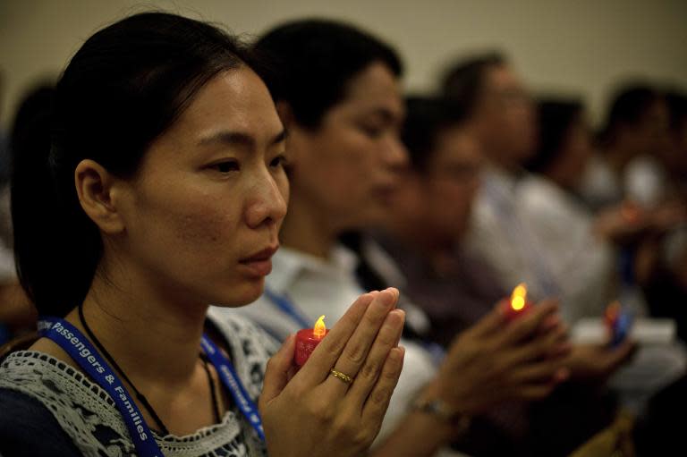 Malaysian Buddhists offering prayers for passengers of missing Malaysia Airlines (MAS) flight MH370 at a Buddhist temple in Kuala Lumpur on March 31, 2014