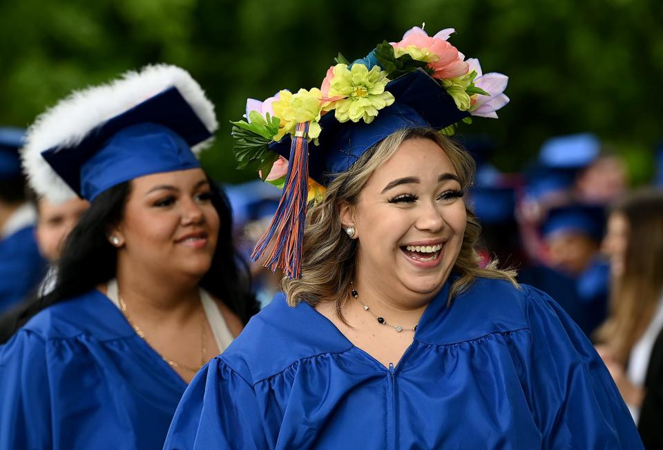 Wearing a flower-covered mortarboard, Keefe Tech graduate Ruth Lugo laughs with a friend before the Keefe Tech graduation at the Warren Conference Center and Inn in Ashland, June 2, 2022.