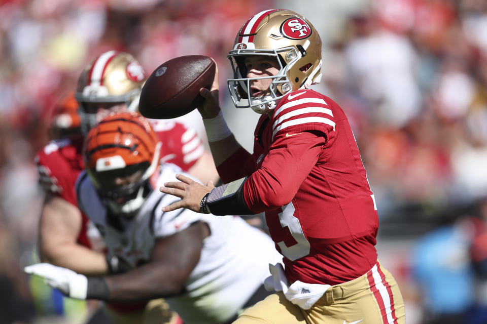 San Francisco 49ers quarterback Brock Purdy rolls out to pass against the Cincinnati Bengals during the first half of an NFL football game in Santa Clara, Calif., Sunday, Oct. 29, 2023. (AP Photo/Jed Jacobsohn)