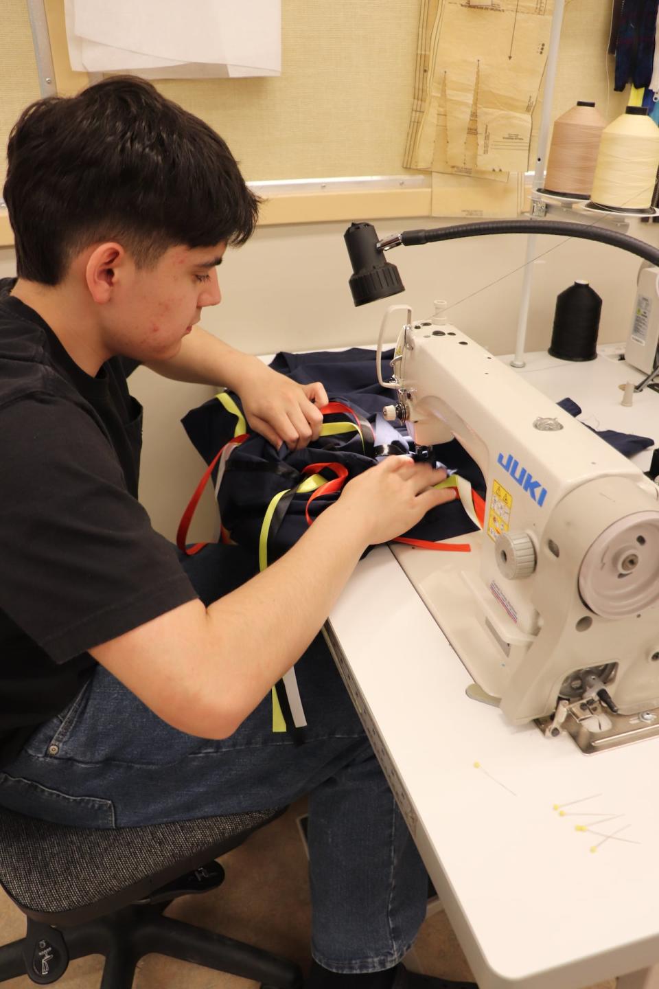 Reese Jackson works on regalia as part of the Northern Cultural Expression Society’s Yukon First Nation Grad Regalia program.