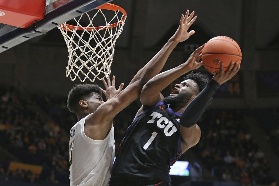 TCU guard Mike Miles Jr. (1) is defended by West Virginia forward Mohamed Wague during the first half of an NCAA college basketball game Wednesday, Jan. 18, 2023, in Morgantown, W.Va. (AP Photo/Kathleen Batten)