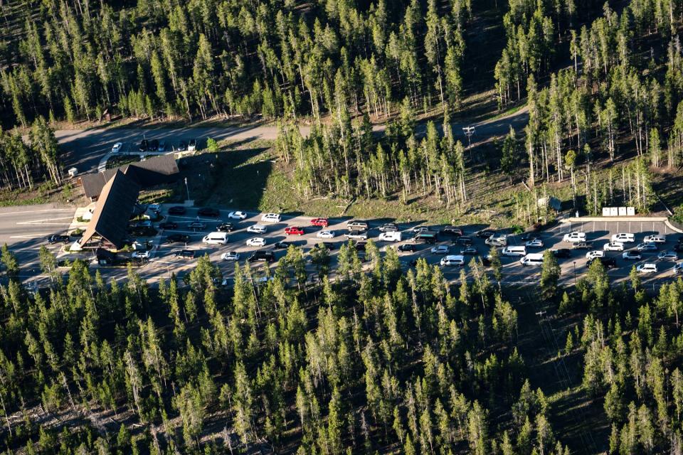 Tourists wait in a long line to enter the park from West Yellowstone entrance in Yellowstone National Park, Wyoming, Thursday, June 23, 2022.