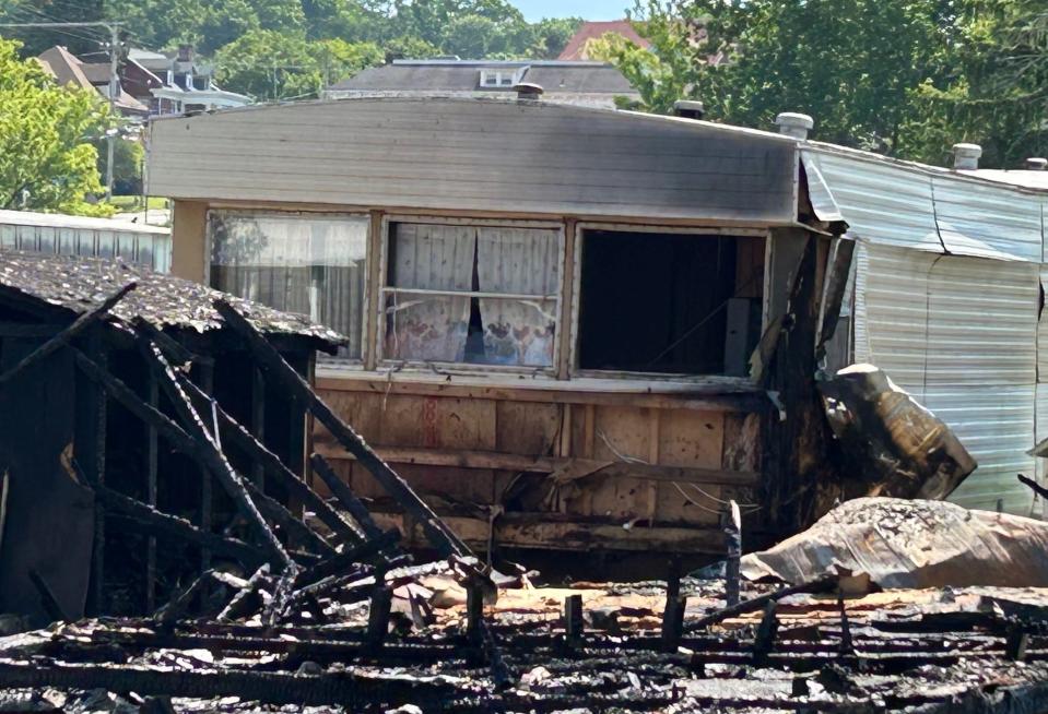 A neighboring trailer that was occupied was severely damaged by the Tuesday night fire.