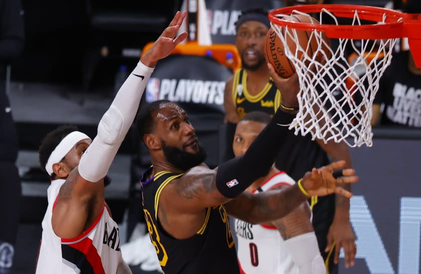 Los Angeles Lakers' LeBron James (23) shoots against Portland Trail Blazers' Carmelo Anthony.