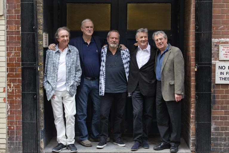 British comedy troupe Monty Python (L-R) Eric Idle, John Cleese, Terry Gilliam, Michael Palin, and Terry Jones pose for a photograph at the back door to the London Palladium in central London on June 30, 2014