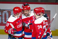 Washington Capitals left wing Alex Ovechkin (8), from Russia, is congratulated by center Nicklas Backstrom (19) from Sweden, defenseman John Carlson (74), and defenseman Radko Gudas (33), from Czech Republic, after scoring during the first period of an NHL hockey game against the New Jersey Devils, Thursday, Jan. 16, 2020, in Washington. (AP Photo/Al Drago)