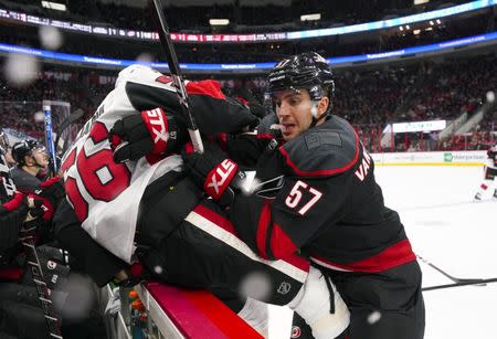 Jan 18, 2019; Raleigh, NC, USA; Carolina Hurricanes defenseman Trevor van Riemsdyk (57) checks Ottawa Senators left wing Magnus Paajarvi (56) during the second period at PNC Arena. The Ottawa Senators defeated the Carolina Hurricanes 4-1. Mandatory Credit: James Guillory-USA TODAY Sports