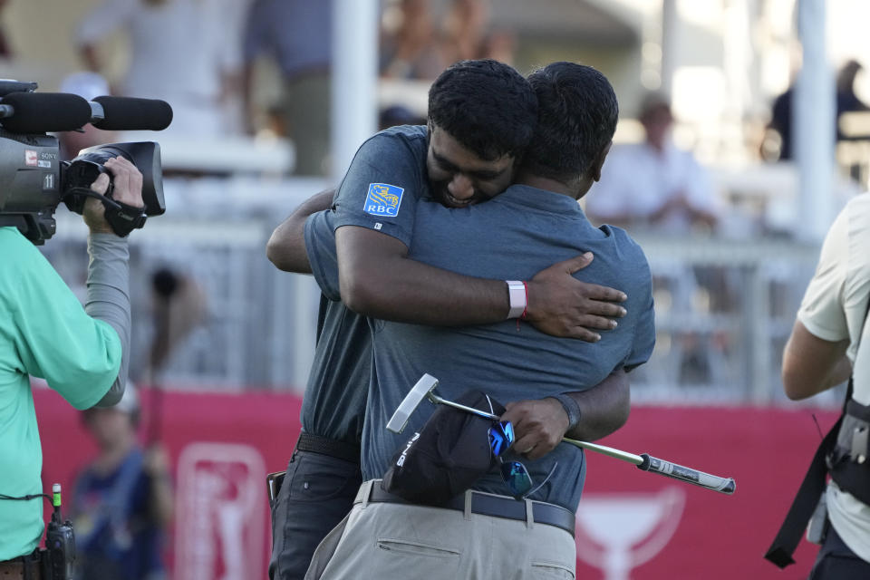 Sahith Theegala hugs his father Muralidhar Theegala on the 18th green of the Silverado Resort North Course after winning the Fortinet Championship PGA golf tournament in Napa, Calif., Sunday, Sept. 17, 2023. (AP Photo/Eric Risberg)
