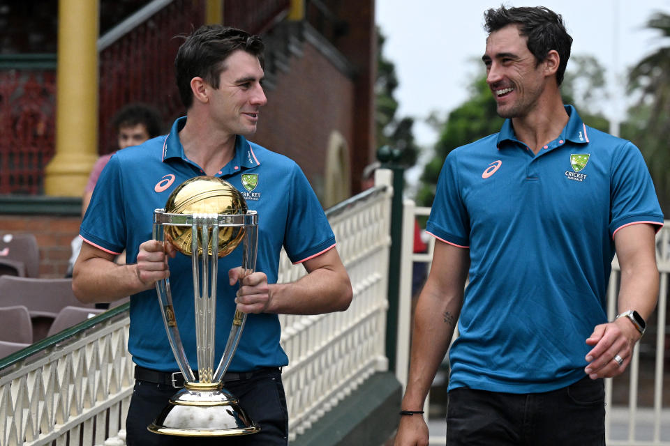 Australian cricketers Pat Cummins (L) and Mitchell Starc walk with the ICC Men's Cricket World Cup 2023 Trophy during a media opportunity at the Sydney Cricket Ground on November 28, 2023. (Photo by Saeed KHAN / AFP) / -- IMAGE RESTRICTED TO EDITORIAL USE - STRICTLY NO COMMERCIAL USE -- (Photo by SAEED KHAN/AFP via Getty Images)