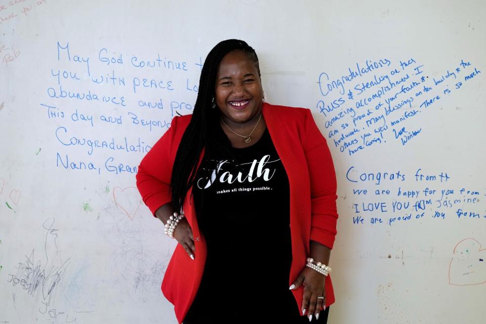 Sterling Clinton-Spellman is surrounded by words of encouragement from her family and friends written on the wall of her future Incred-A-Bowl restaurant in East Providence, which will complement her food truck business of the same name.