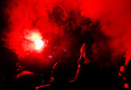 Anti-fascist activists with a flare react during an open air "anti-racism concert" in Chemnitz, Germany, September 3, 2018. REUTERS/Hannibal Hanschke