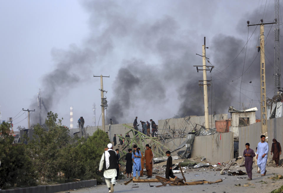 Smoke billows from the Green Village, home to several international organizations and guesthouses, in Kabul, Afghanistan, Tuesday, Sept. 3, 2019. Angry residents climbed into the international compound that had been targeted and set part of it on fire. (AP Photo/Rahmat Gul)