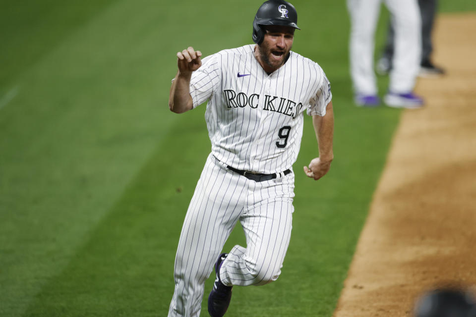 Colorado Rockies' Daniel Murphy scores on a double by Raimel Tapia off Arizona Diamondbacks starting pitcher Alex Young during the eighth inning of a baseball game Tuesday, Aug. 11, 2020, in Denver. The Rockies won 8-7. (AP Photo/David Zalubowski)