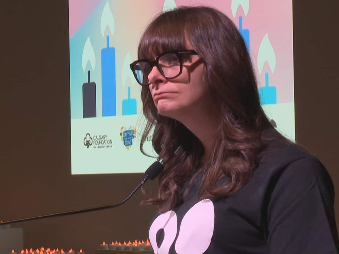 Anna Murphy speaks to a group of Calgarians during a ceremony to remember the lives of transgender individuals who have died. Murphy herself is a transgender woman and shared her story with those in attendance. (Terri Trembath/CBC - image credit)