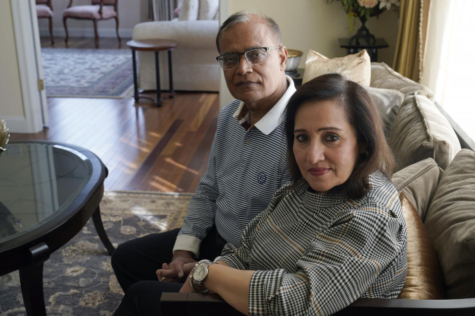 Vinita Rampuria, front, and her husband Ashoke Rampuria, of Acton, Mass., sit for a photograph, Tuesday, April 4, 2023, at their home in Acton. The couple, whose son has struggled with mental illness and has been in and out of mental health care facilities for more than a decade, are supporting efforts in Massachusetts to create a new law that would let judges order the severely mentally ill into mandatory outpatient care after being released from a mental health institution. Massachusetts is one of only three states that don't give the courts that authority. (AP Photo/Steven Senne)