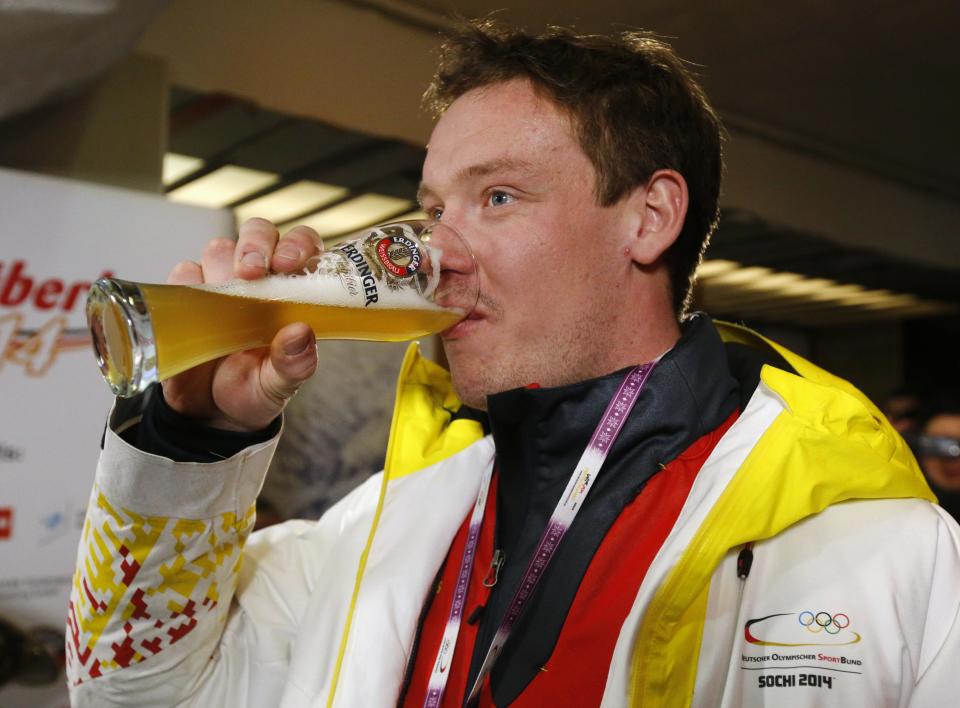 Germany's Felix Loch drinks a beer at the German house after winning the men's singles luge event at the 2014 Sochi Winter Olympics, in Rosa Khutor February 10, 2014. REUTERS/Fabrizio Bensch (RUSSIA - Tags: SPORT LUGE OLYMPICS)