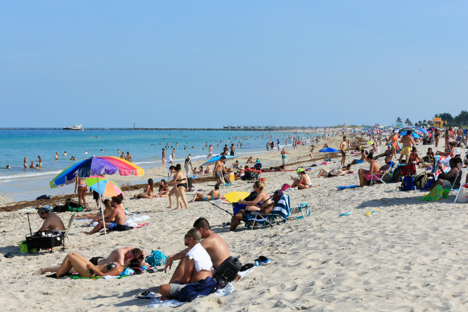 MIAMI BEACH, FLORIDA - JUNE 10:  Beachgoers take advantage of the opening of South Beach on June 10, 2020 in Miami Beach, Florida. Miami-Dade county and the City of Miami opened their beaches today as the area eases restrictions put in place to contain COVID-19. (Photo by Cliff Hawkins/Getty Images)