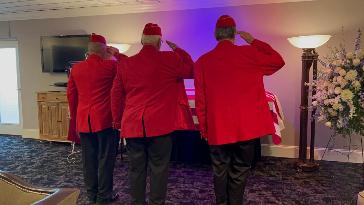 Members of the Music City Detachment 378 of the Marine Corps League salute the the casket containing the remains of Cpl. William Ragsdale during a visitation August 5, 2022.