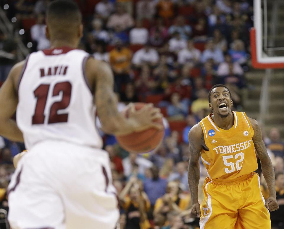 Tennessee guard Jordan McRae (52) watches Massachusetts guard Trey Davis (12) come down the court during the first half of an NCAA college basketball second-round tournament game, Friday, March 21, 2014, in Raleigh. (AP Photo/Gerry Broome)