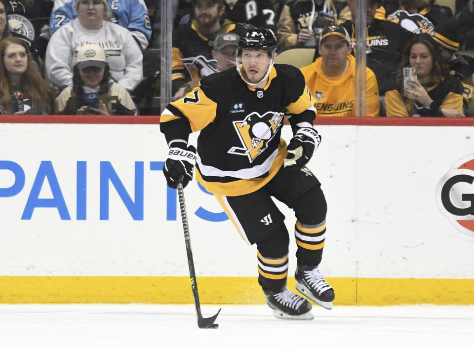 Pittsburgh Penguins defenseman Dmitry Kulikov (7) skates with the puck while playing the Columbus Blue Jackets during the second period of an NHL hockey game, Tuesday, March 7, 2023, in Pittsburgh. (AP Photo/Philip G. Pavely)