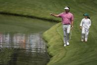Bubba Watson walks with his daughter, Dakota on the fifth hole during the par-3 contest at the Masters golf tournament at Augusta National Golf Club Wednesday, April 10, 2024, in Augusta, GA. (AP Photo/Charlie Riedel)