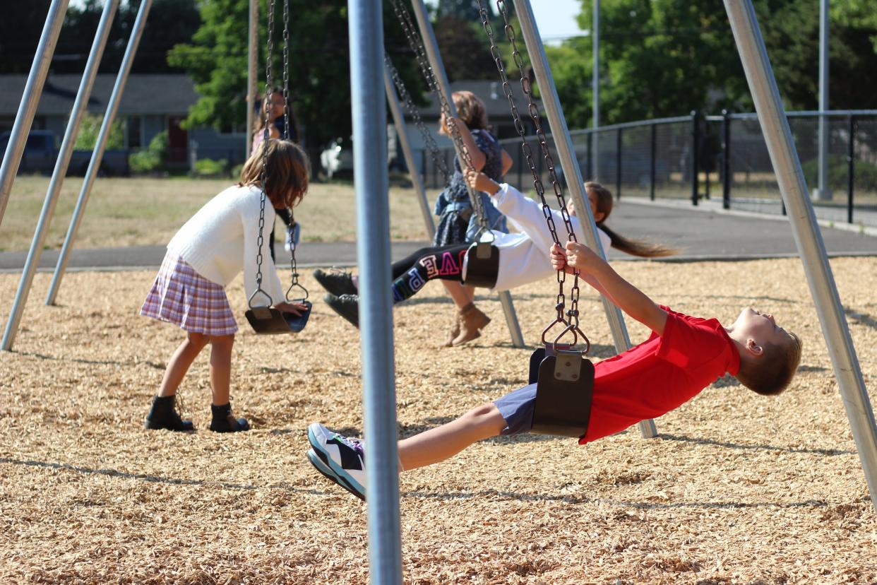 Fifth-grade students in Fairfield Elementary School play during recess on the first day of school Sept. 6 in Eugene, Oregon. Students can now play with different classes during recess, a loosening of COVID protocols.