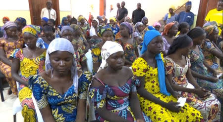 FILE PHOTO: A still image taken from video shows a group of girls, released by Boko Haram jihadists after kidnapping them in 2014 in the north Nigerian town of Chibok, sitting in a hall as they are welcomed by officials in Abuja, Nigeria, May 7, 2017. REUTERS/via Reuters TVREUTERS/ /File Photo