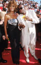 The late-singer Whitney Houston and then-husband Bobby Brown had a red carpet moment at the 1998 Emmy Awards. (Photo by: Getty Images)