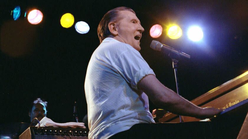 FILE--Jerry Lee Lewis performs at the Camel Rock Casino in Tesuque, N.M., May 27, 2000. Three cousins from a Mississippi Delta town spent their childhood together, peeking into blues clubs, pounding out piano tunes and creating their own rock 'n' roll before the music even had a name. Jimmy Swaggart, Mickey Gilley and Lewis took dramatically different paths in their careers. The three cousins are to reunite for the first time in a decade on Saturday when they will be inducted into the Delta Music Museum Hall of Fame in Ferriday,La. (AP Photo/Sarah Martone, File)