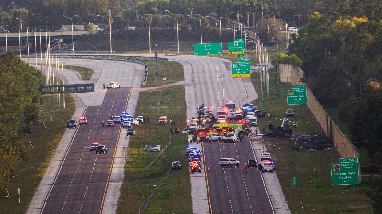 Emergency officials work the scene of plane crash on I-75 in Naples near exit 105 on Friday, Feb. 9, 2024. Two people were confirmed dead.