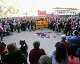 Fans lay scarves and flags outside the ground.