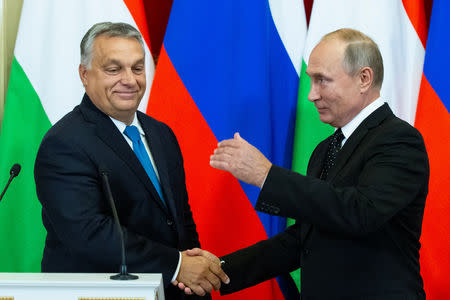 Russian President Vladimir Putin shakes hands with Hungarian Prime Minister Viktor Orban during a joint news conference following their talks at the Kremlin in Moscow, Russia September 18, 2018. Alexander Zemlianichenko/Pool via REUTERS