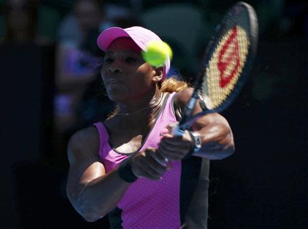 Serena Williams of the U.S. hits a return to Daniela Hantuchova of Slovakia during their women's singles matchat the Australian Open 2014 tennis tournament in Melbourne January 17, 2014. REUTERS/Petar Kujundzic