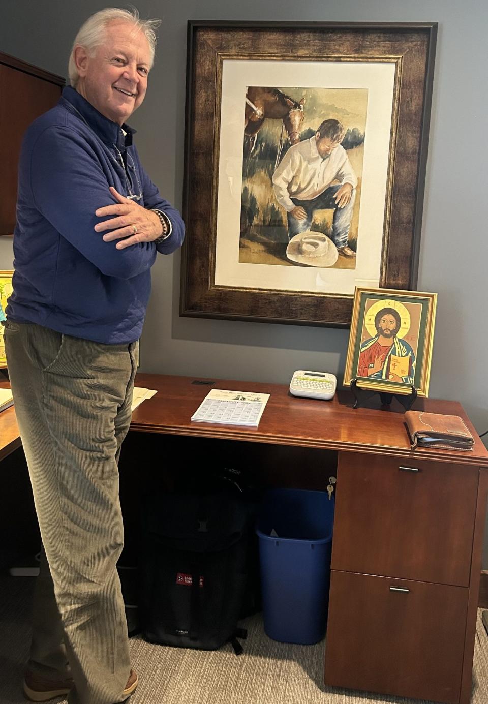 The Rev. Dr. Jerry Askew has a painting of an urban cowboy by Kim Kimmons at his desk in the offices of the Episcopal Diocese of East Tennessee, where he serves multiple roles. "The painting reminds me that the toughest guy needs to remember where his strength comes from," Askew said. Askew created the icons that are on his desk.