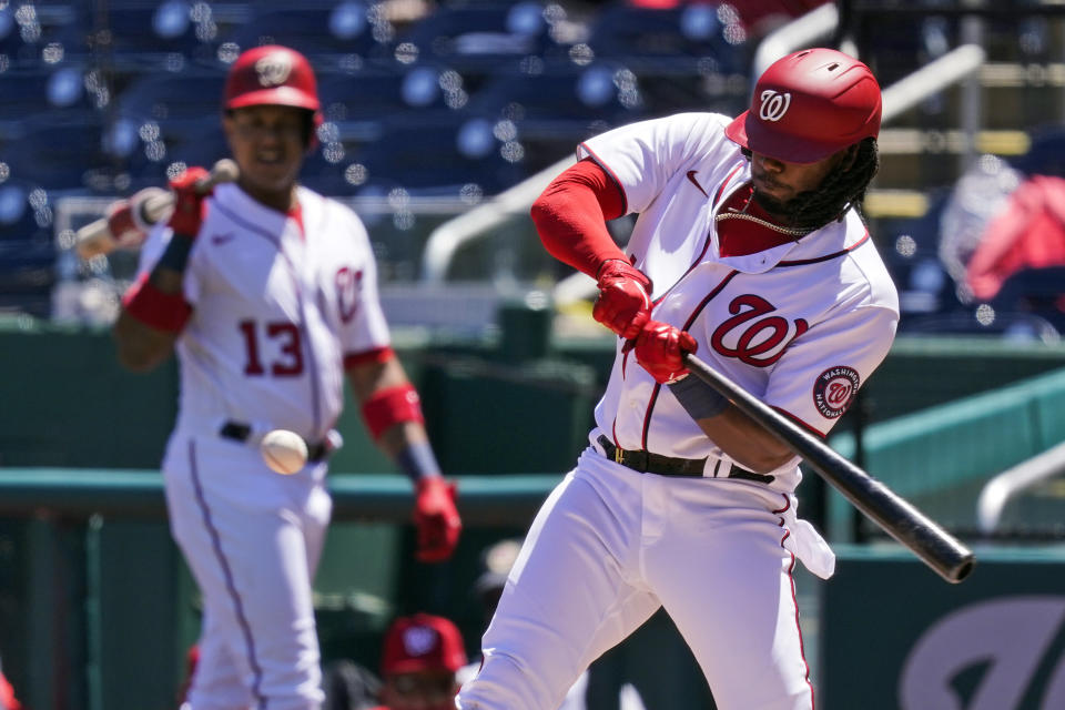 Washington Nationals' Josh Bell hits an RBI single during the first inning of a baseball game against the Miami Marlins at Nationals Park, Saturday, May 1, 2021, in Washington. (AP Photo/Alex Brandon)