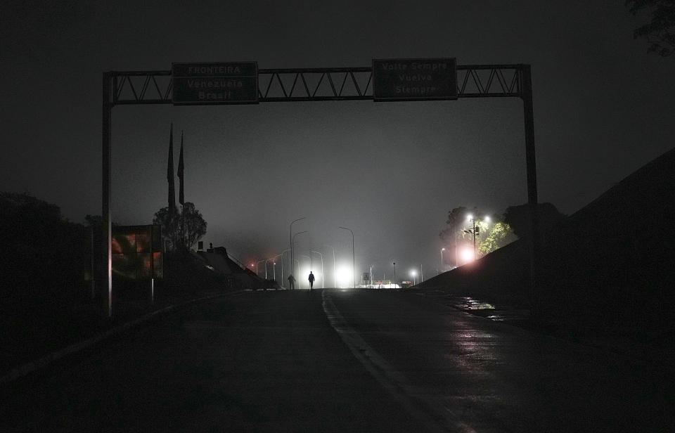 Venezuelan migrants cross the Venezuelan border to Pacaraima, Brazil, early Thursday, April 27, 2023. (AP Photo/Matias Delacroix)