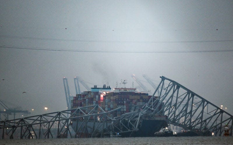 The collapsed Francis Scott Key Bridge lies on top of the container ship Dali in Baltimore, Maryland, on March 27, 2024. Authorities in Baltimore were set to focus on expanding recovery efforts on March 27 after the cargo ship slammed into the bridge, causing it to collapse and leaving six people presumed dead. All six were members of a construction crew repairing potholes on the bridge when the structure fell into the Patapsco River at around 1:30 am (0530 GMT) on March 26. - Photo: ROBERTO SCHMIDT/AFP (Getty Images)