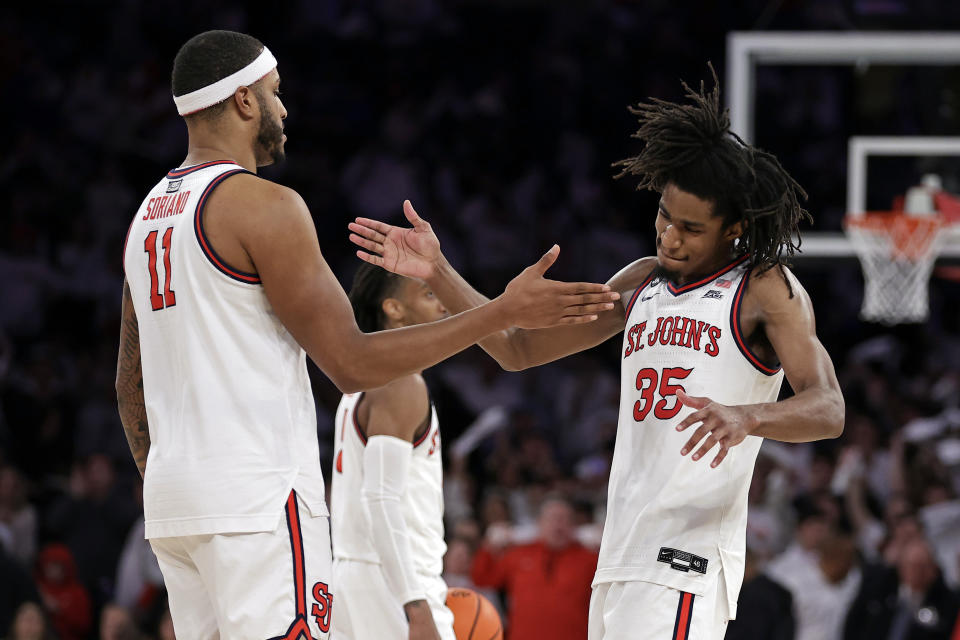 St. John's forward Glenn Taylor Jr. (35) and Joel Soriano (11) celebrate in the last minute of play against Creighton during the second half of an NCAA college basketball game, Sunday, Feb. 25, 2024, in New York. (AP Photo/Adam Hunger)