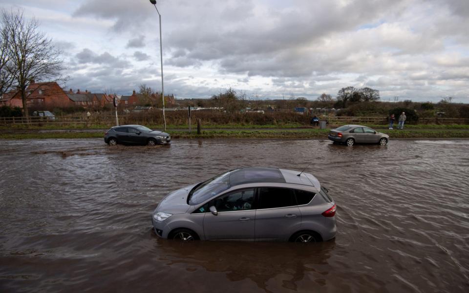 Cars have become stranded in floodwater on Derby Road in Hathern, Leicestershire - Joe Giddens/PA