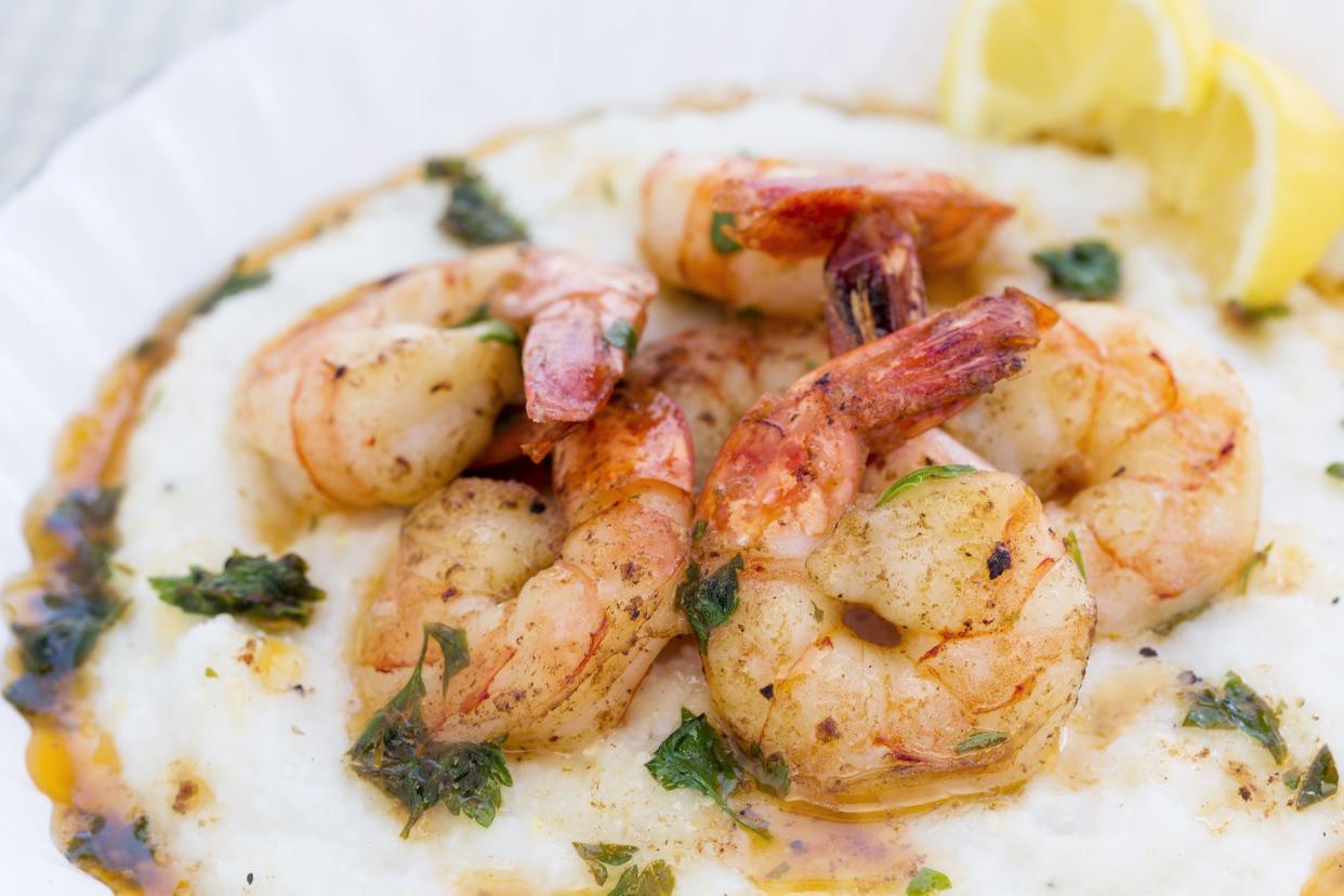 A hearty bowl of plump shrimp over buttery, savory grits.